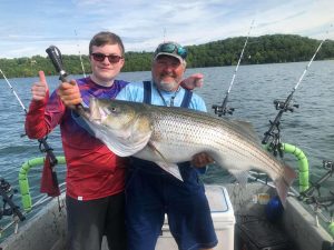 Beaver Lake Striper Fishing Guide with a young man and his first striped bass
