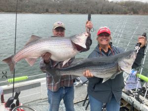 Beaver Lake Striper Fishing Guide with a nice couple and their trophy fish